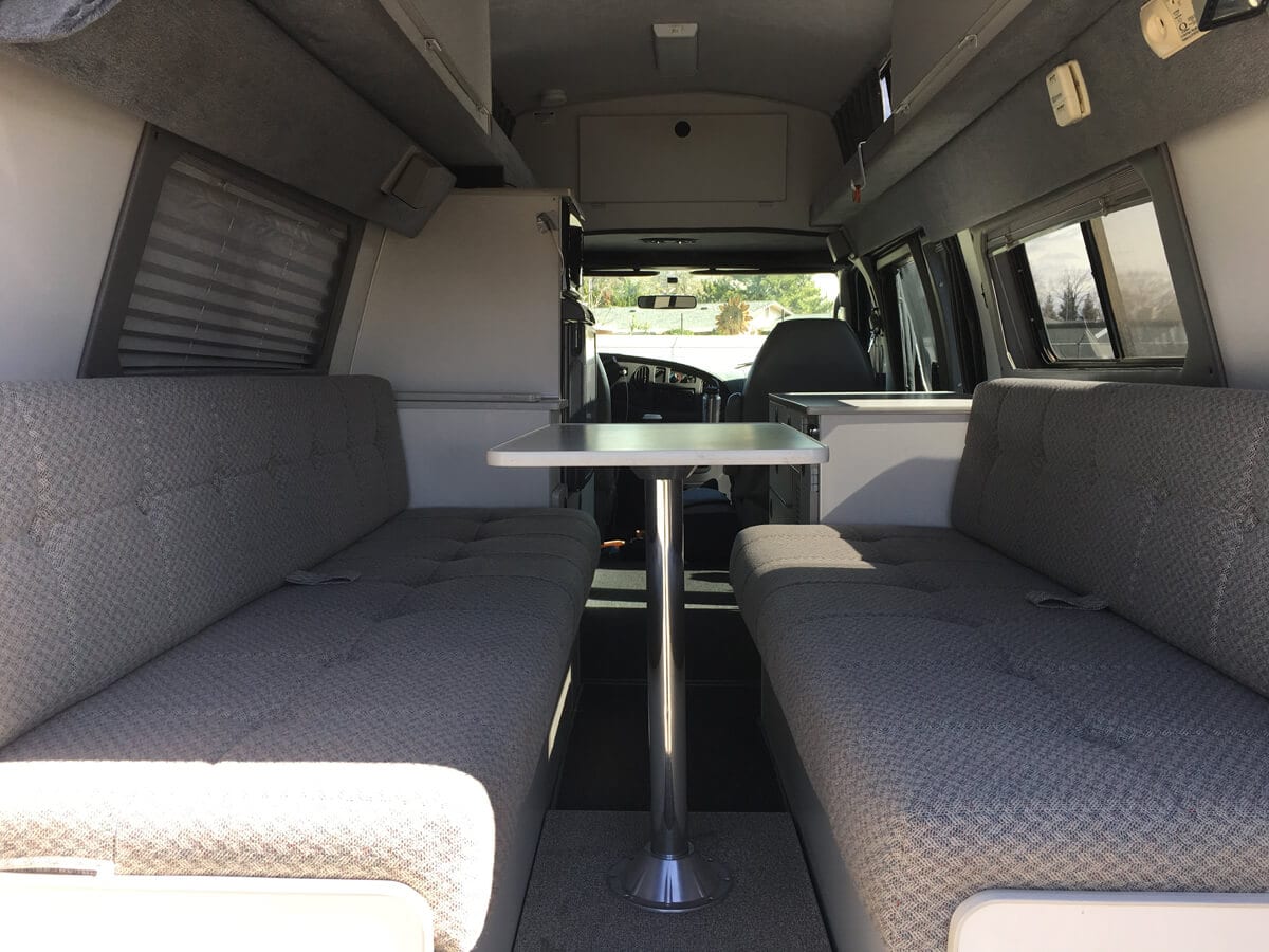 Back bench seats inside a 2005 Sportsmobile Ford Econoline camper van rental in oregon