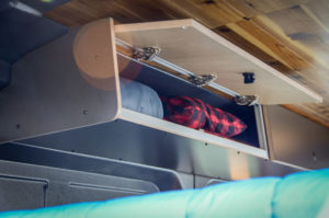 Upper storage cabinets converted Ford Transit campervan in Oregon with 2 beds and kitchen