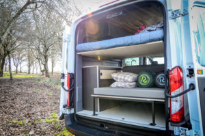Rear view of converted Ford Transit campervan in Oregon with 2 beds and kitchen