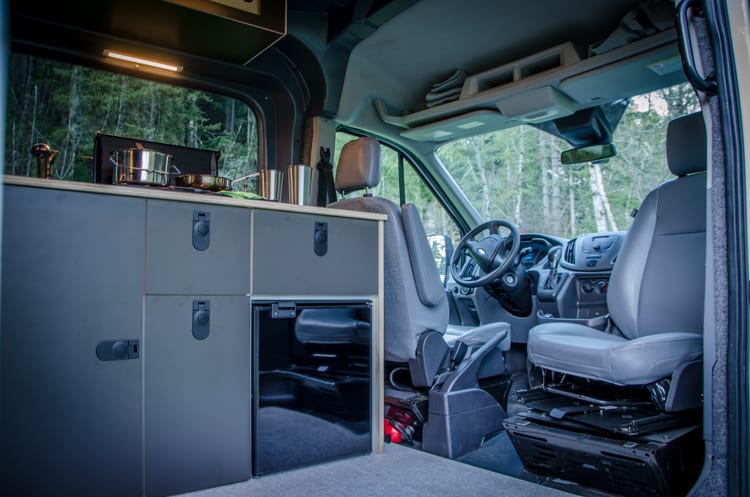 Interior shot of front passenger swivel seat in Ford Transit Campervan built by Axis Vehicle Outfitters in Portland, Oregon