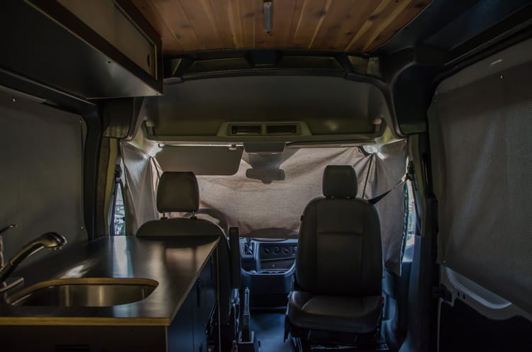 Window coverings for privacy in a Ford Transit Campervan built by Axis Vehicle Outfitters in Portland, Oregon