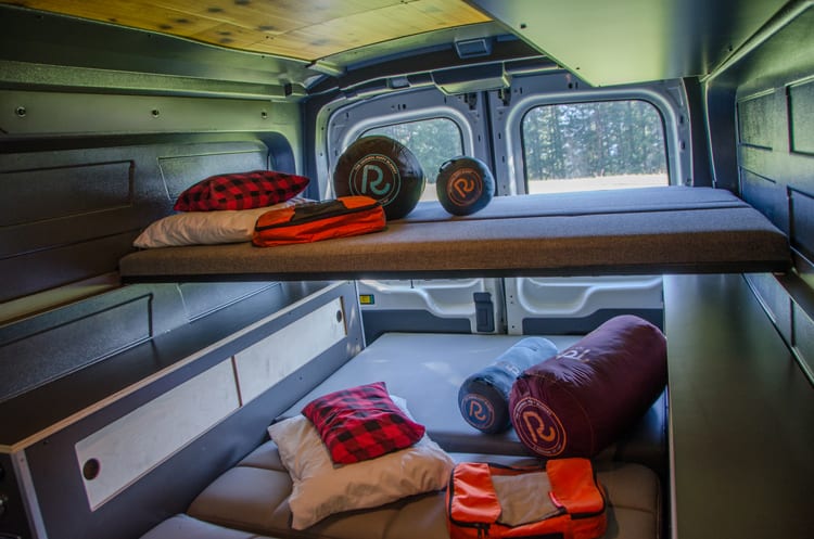 Interior bed set up in a Ford Transit Campervan built by Axis Vehicle Outfitters in Portland, Oregon
