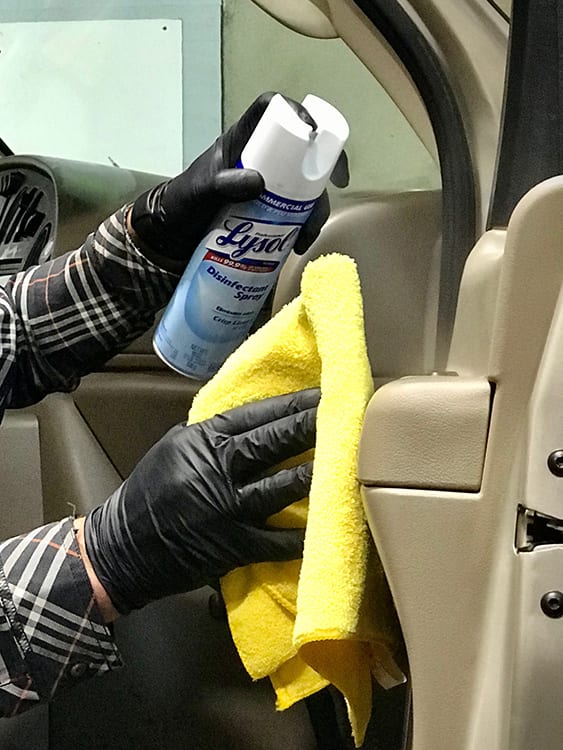 Cleaning our camper van rental fleet with hospital grade disinfectant wipes on a 4wd Ford Econoline Sportsmobile to disinfect against the coronavirus