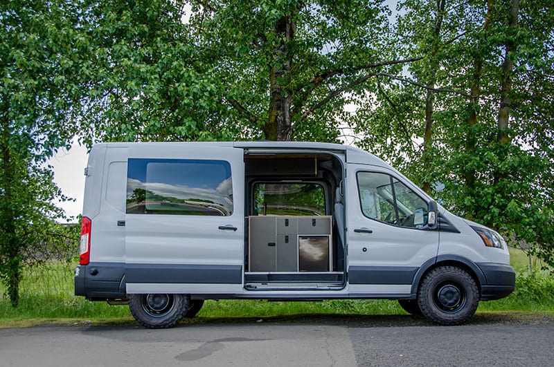 Exterior shot of passenger side of Ford Transit Campervan for sale built by Axis Vehicle Outfitters in Portland, Oregon