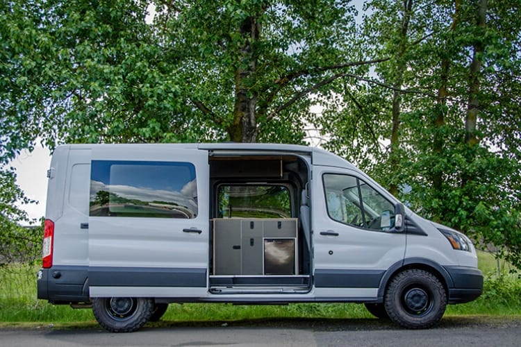 Exterior shot of passenger side of Ford Transit Campervan for sale built by Axis Vehicle Outfitters in Portland, Oregon