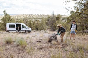 Roamerica converted campervan Ford Transit in Oregon High Desert road trip and chopping wood