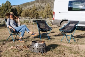 Roamerica converted campervan Ford Transit in Oregon High Desert road trip and chopping wood